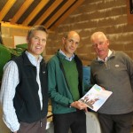 Phil Davies (C), Founding Director of Community Energy Cumbria shows the Share Offer Document to Clive Wickham (L), Partnerships Manager at LDNP and Dave Townley (R), Site Manager for Ellergreen Hydro.