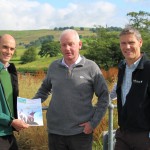 Phil Davies (L), Founding Director of Community Energy Cumbria shows the Share Offer Document to Clive Wickham (R), Partnerships Manager at LDNP and Dave Townley (C), Site Manager for Ellergreen Hydro.